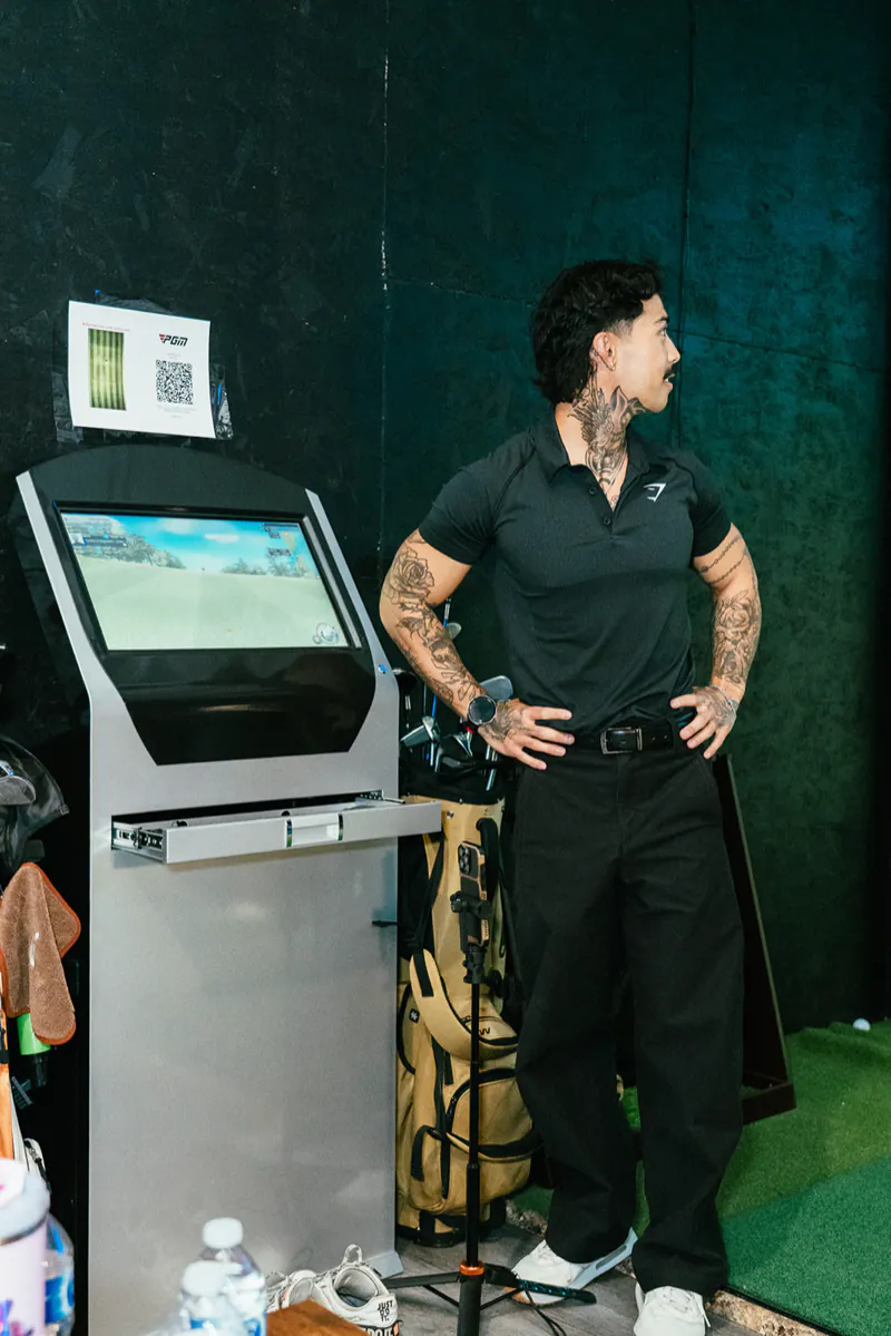 The touchscreen kiosk beside the hitting area in a simulator bay